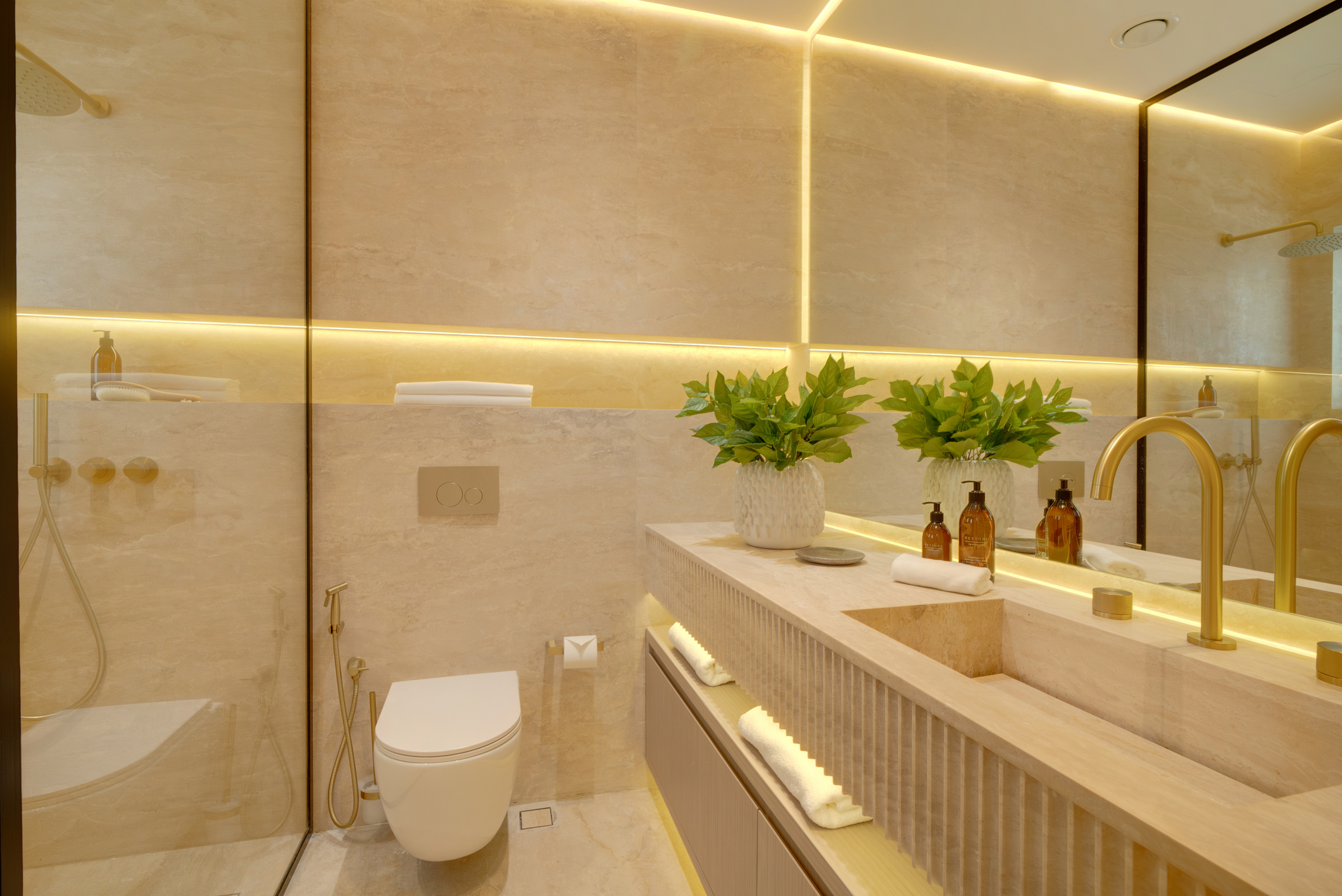 Travertine ensuite with brushed brass